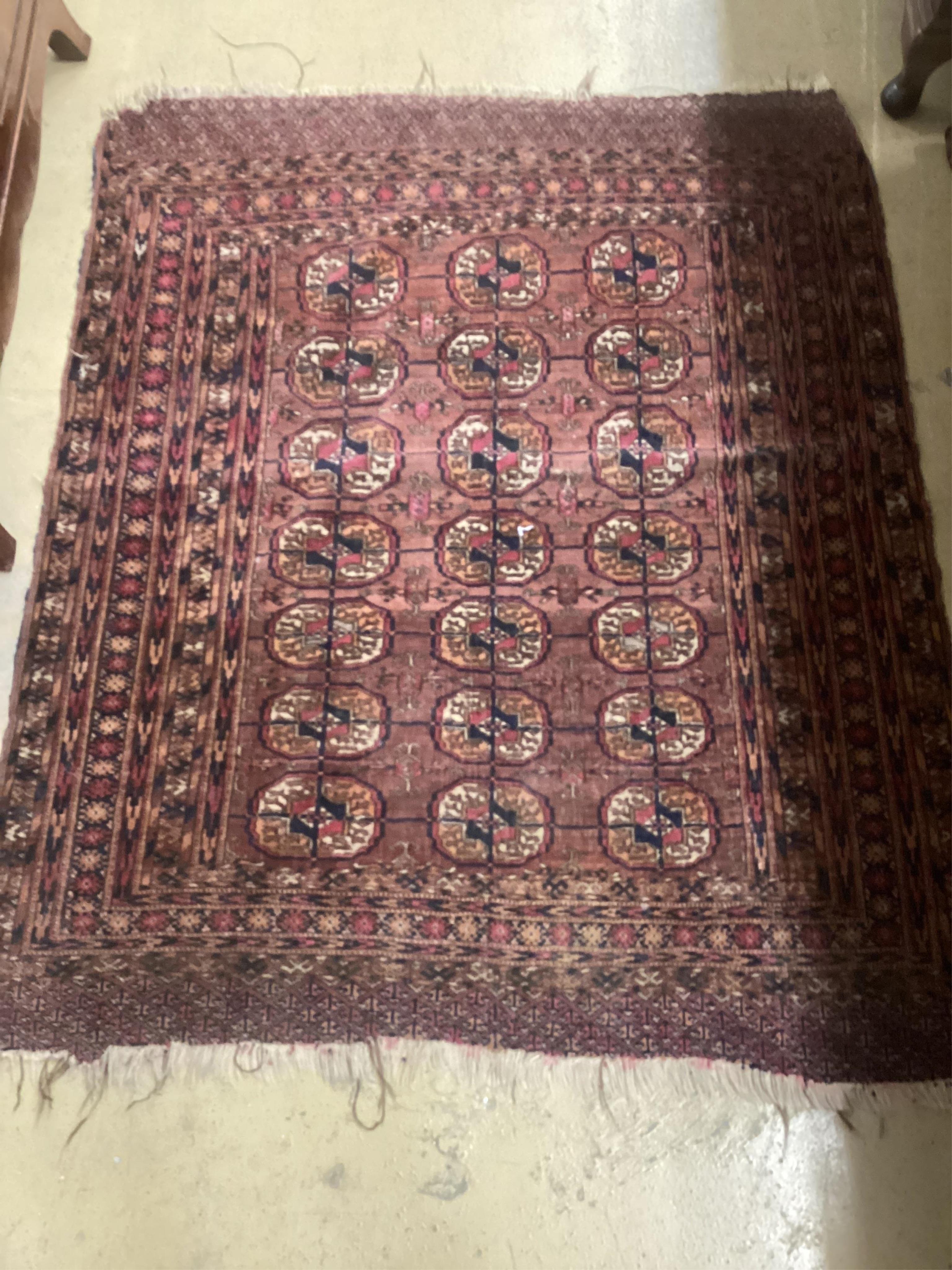 A Tekke plum ground rug, 130 x 110cm. Condition - fair